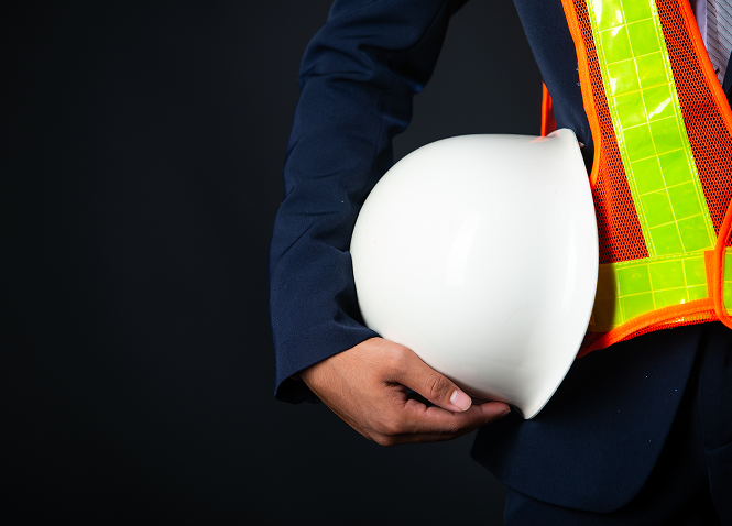 Marine safety professional holding a hard hat
